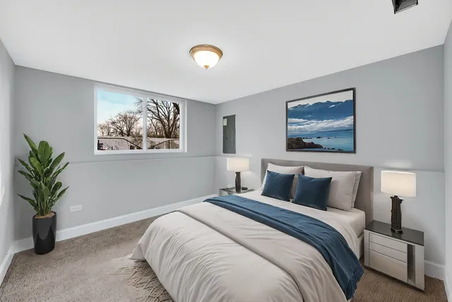 a bedroom with a large bed and a potted plant