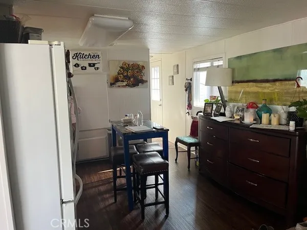 a room with a refrigerator and a table in it