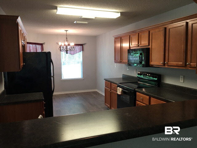 226 Montclair Loop Daphne, AL 36526 - Photo 6 of 27 226 Montclair Loop | Lake Forest | Tile Floor | LVT Flooring | Black Appliances | Back Deck