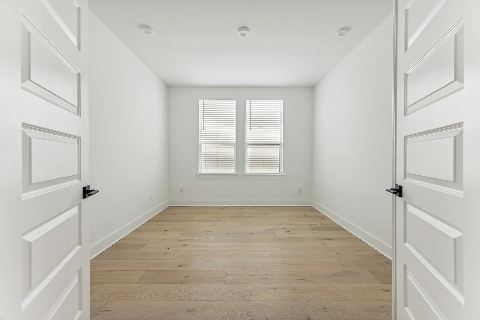1909 Varese Path Leander, TX 78641 - Photo 22 of 40 A well-lit, private room boasts recessed lighting and durable hardwood flooring.