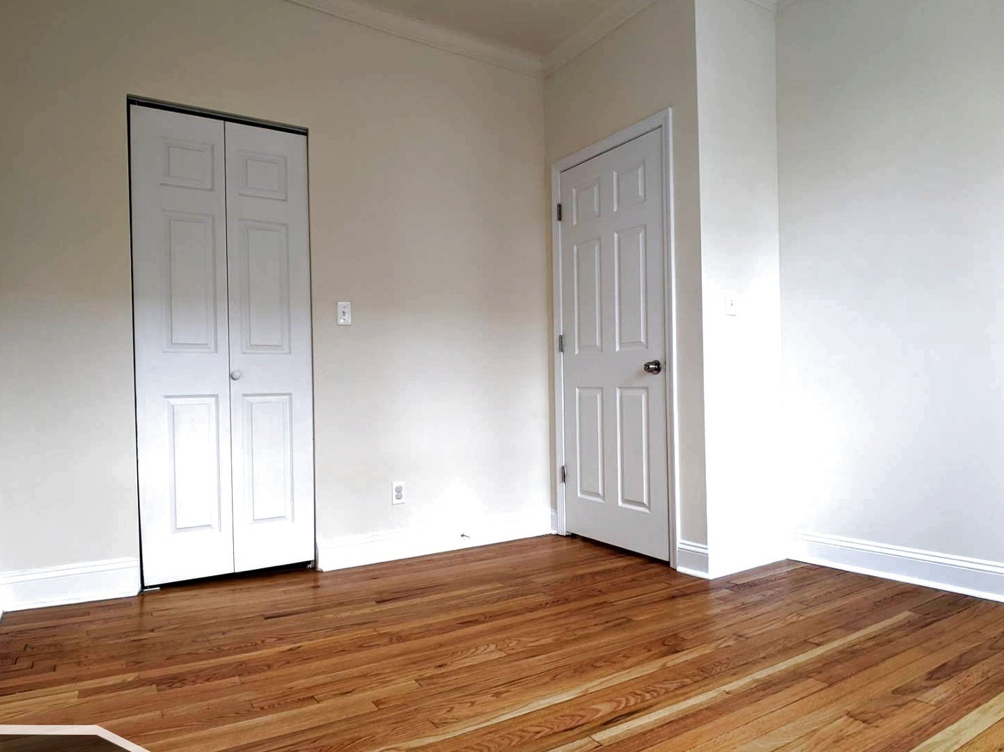 2919 West George Street, Unit 2 Chicago, IL 60618 - Photo 9 of 14 an empty room with wooden floor and closet area