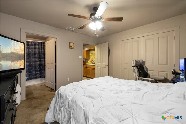 a bedroom with a bed and a flat screen tv