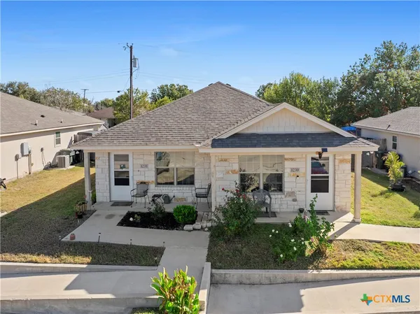 a front view of a house with a garden