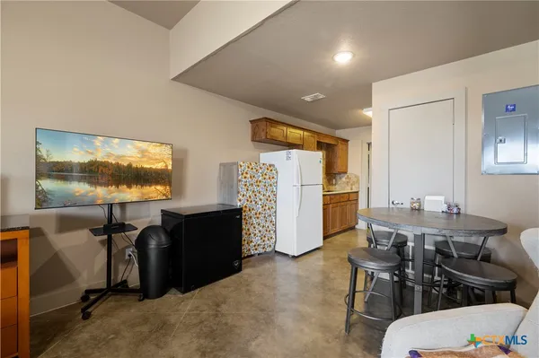 a living room with furniture a flat screen tv and a window