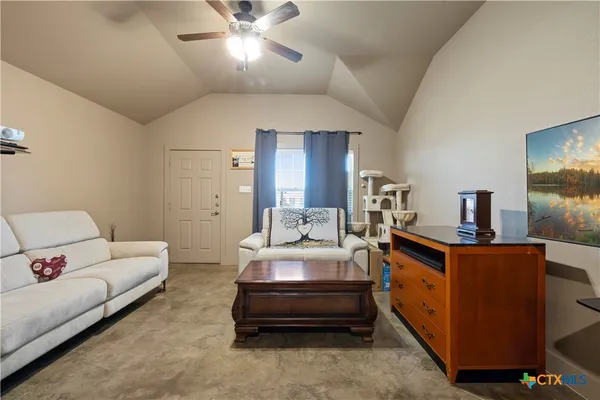 a living room with furniture and a flat screen tv