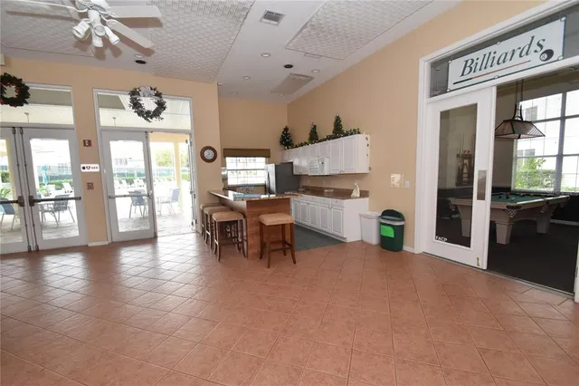 a view of a workspace with furniture and floor to ceiling window