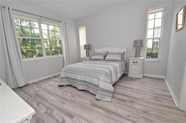 a bedroom with a bed and a large window