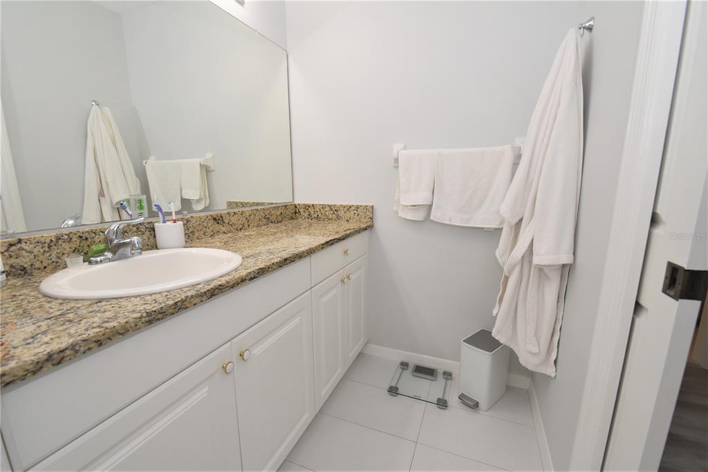 4235 Castle Bridge, Unit 1216 Sarasota, FL 34238 - Photo 7 of 18 a bathroom with a granite countertop sink and a mirror