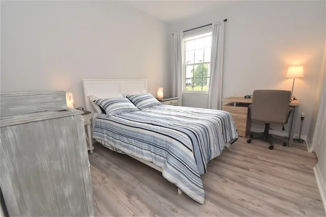 a bedroom with a bed chair and a window