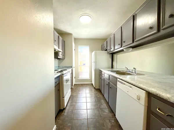 a kitchen with stainless steel appliances granite countertop a sink and cabinets