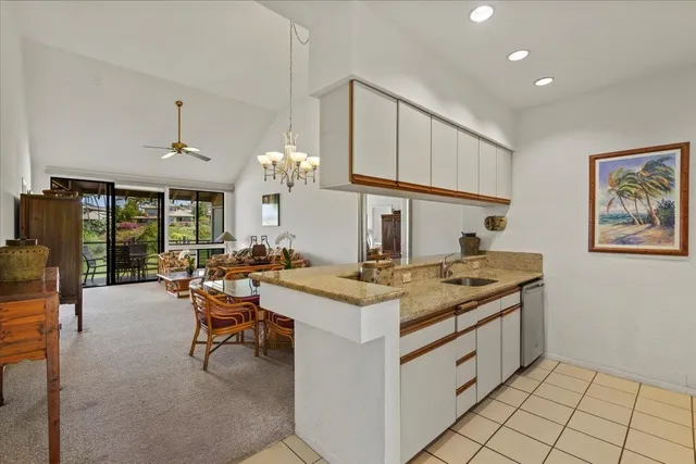 a kitchen with stainless steel appliances granite countertop a refrigerator and a stove