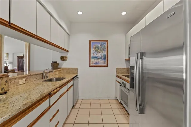a view of a swimming pool with a chair and palm trees
