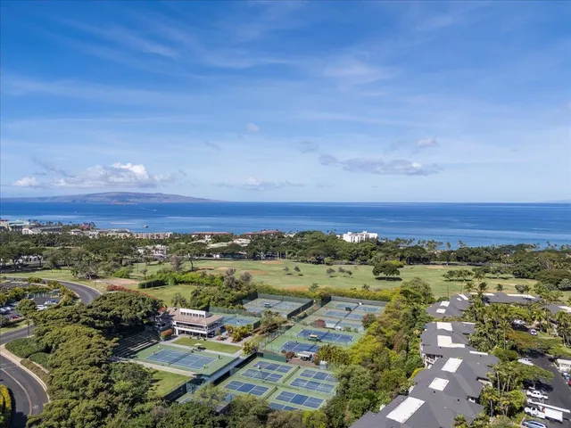 a room with gym equipment and large windows