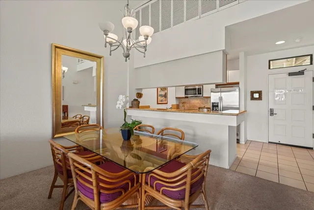 a bedroom with two beds and a chandelier