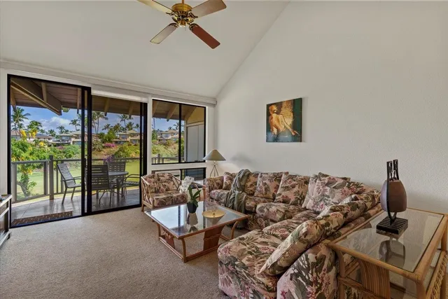 a living room with furniture a flat screen tv and a window