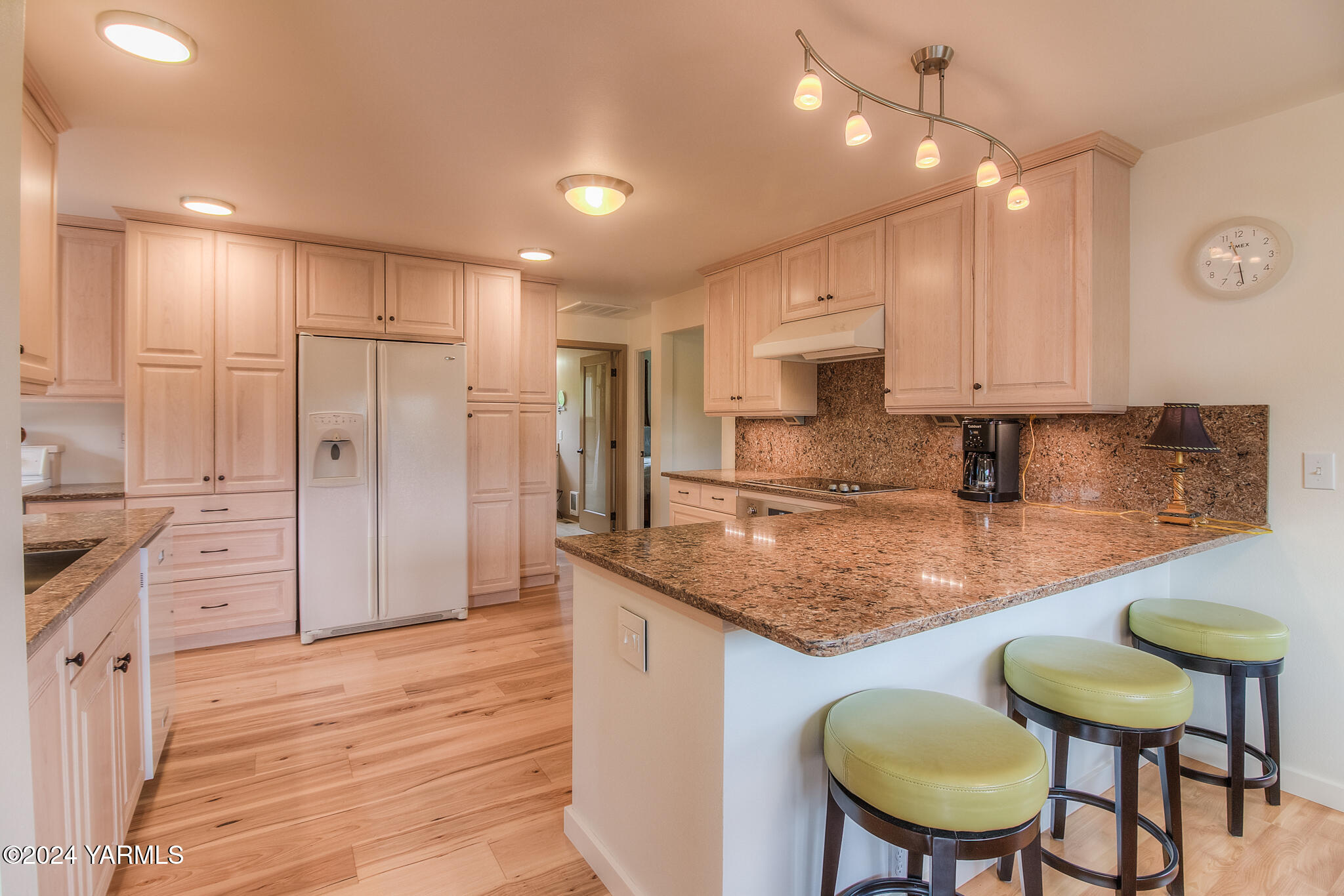 1071 Humphrey Road Tieton, WA 98947 - Photo 8 of 40 a kitchen with stainless steel appliances granite countertop a stove a refrigerator sink cabinets and wooden floor