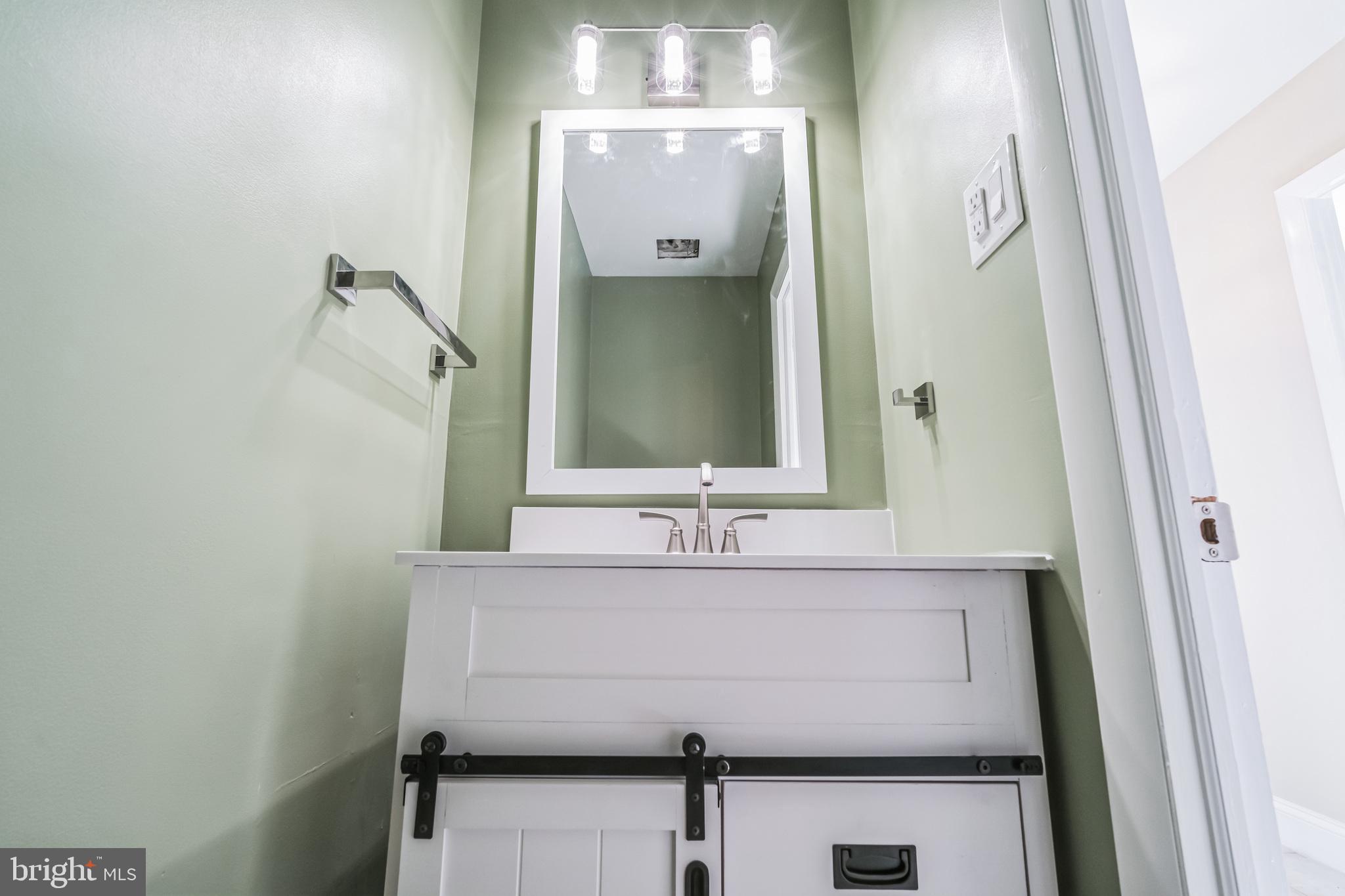 1179 Putnam Boulevard, Unit 3 Wallingford, PA 19086 - Photo 6 of 9 a bathroom with a sink and a mirror
