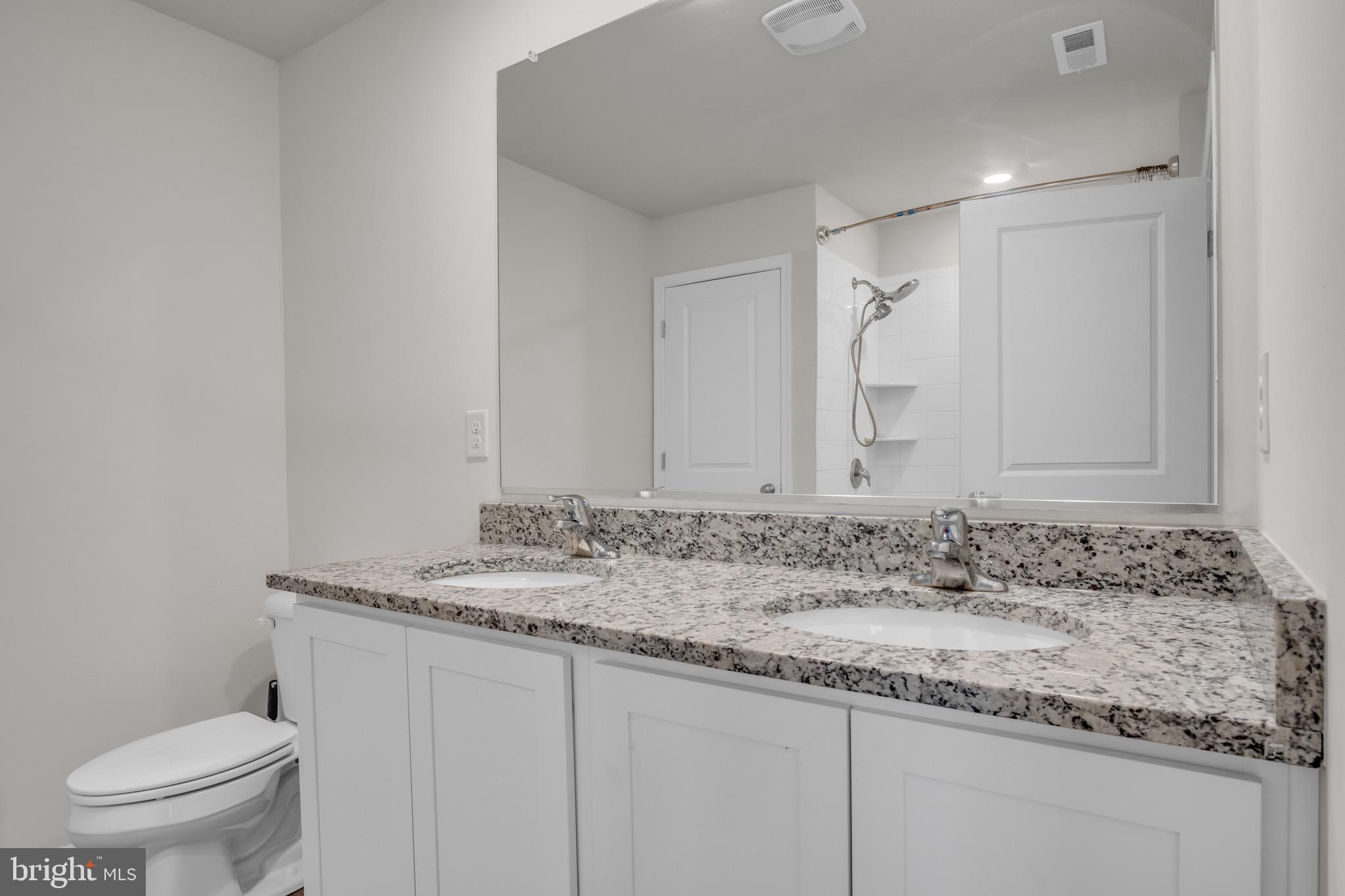 18 Smokehouse Road Carlisle, PA 17013 - Photo 18 of 33 a bathroom with a granite countertop sink a toilet and a mirror