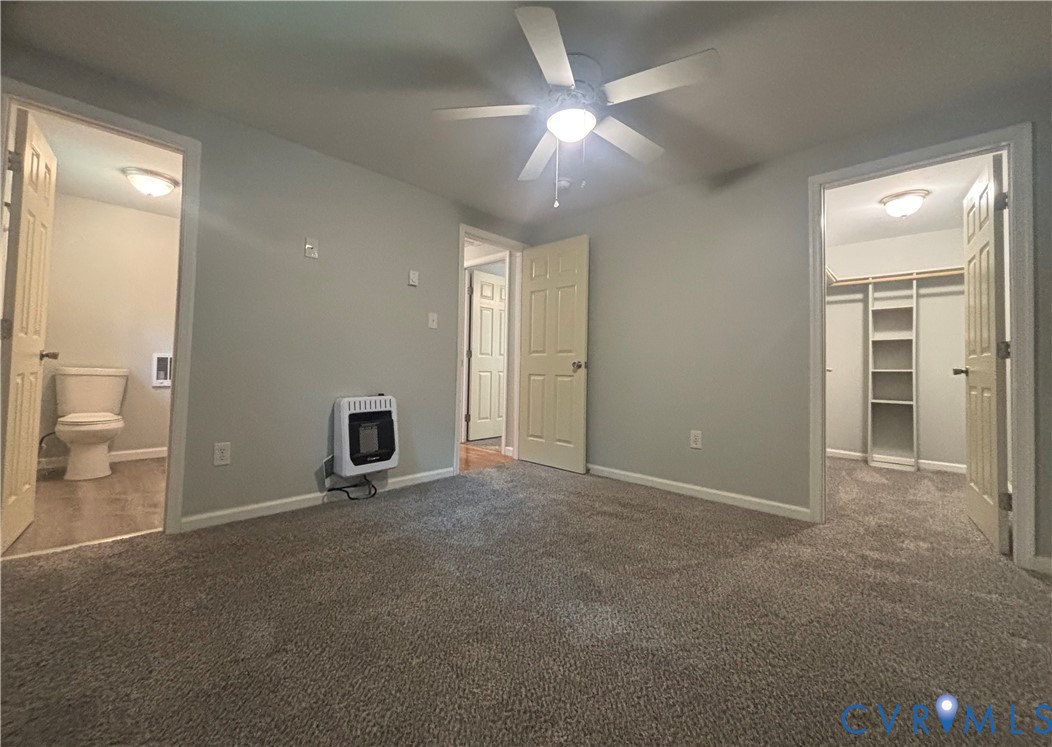 128 North Sylvan Road Waverly, VA 23890 - Photo 15 of 22 Primary bedroom has walk-in closet and en suite ba