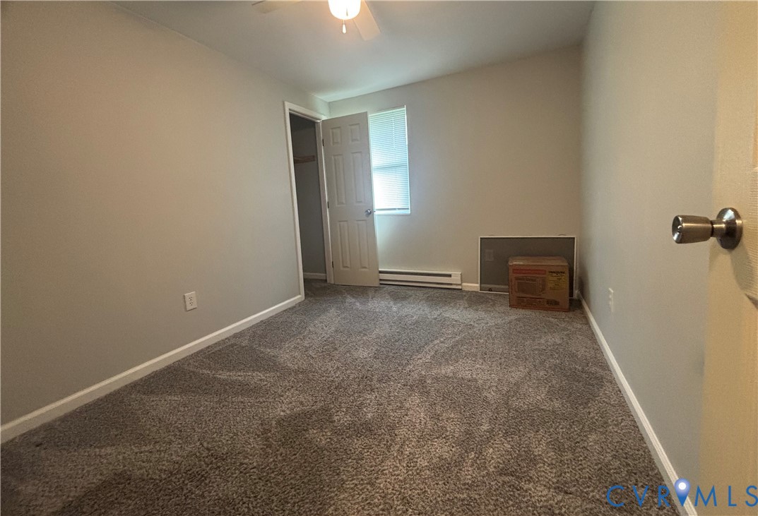 128 North Sylvan Road Waverly, VA 23890 - Photo 18 of 22 Second bedroom has carpet, and ceiling fan.