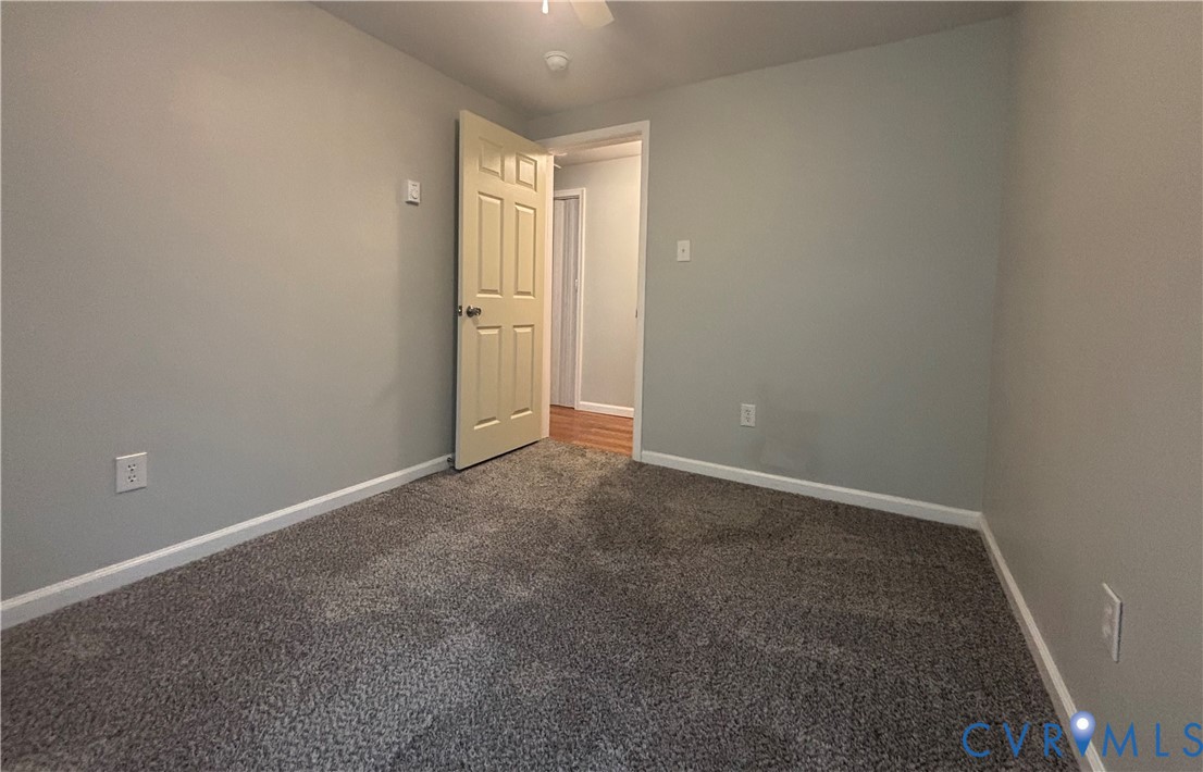 128 North Sylvan Road Waverly, VA 23890 - Photo 19 of 22 Third bedroom has carpet and ceiling fan.