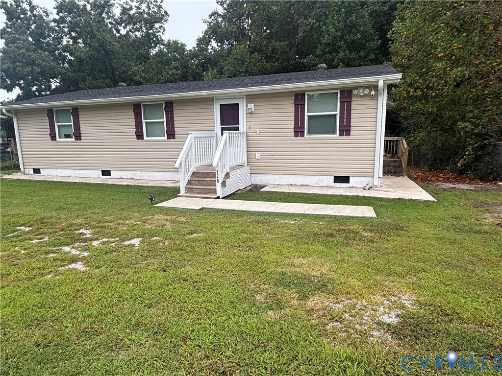 128 North Sylvan Road Waverly, VA 23890 - Photo 3 of 22 Vinyl siding, concrete sidewalks offer low mainten