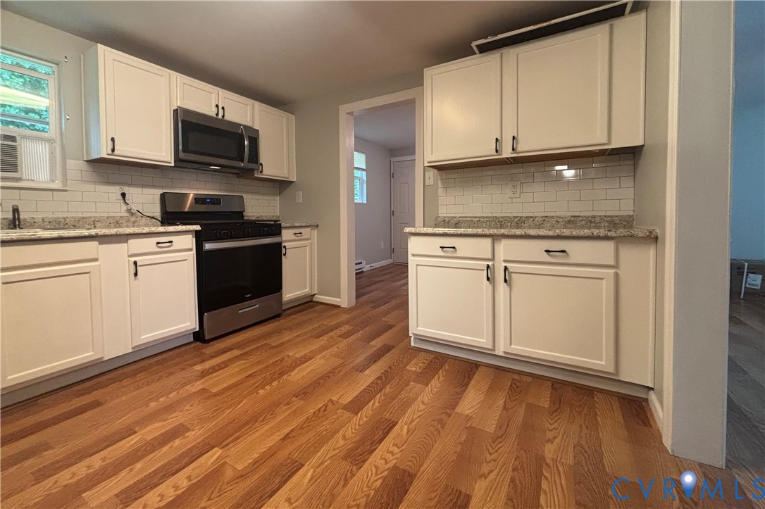 128 North Sylvan Road Waverly, VA 23890 - Photo 10 of 22 Kitchen features new cabinets, built-in microwave,