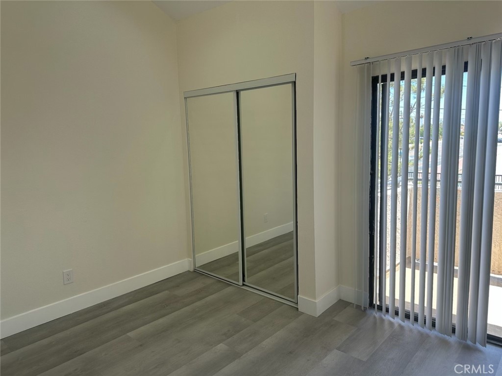 44155 10th Lancaster, CA 93534 - Photo 8 of 15 an empty room with wooden floor and windows