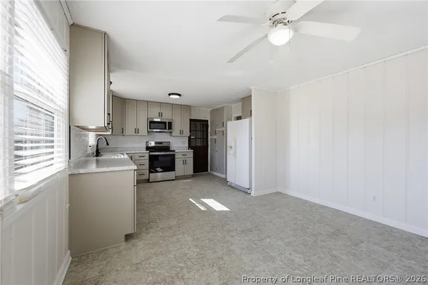 a kitchen with refrigerator and cabinets