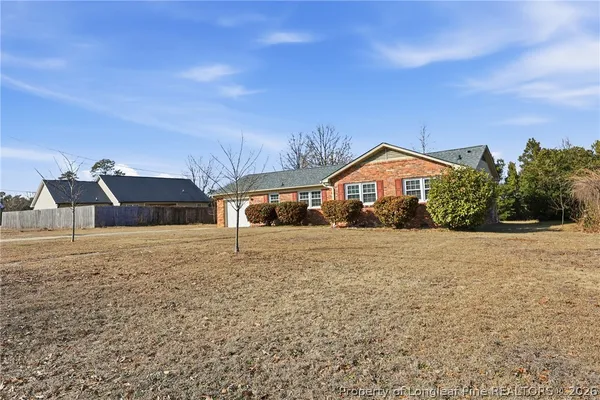 a front view of house with yard and car parked
