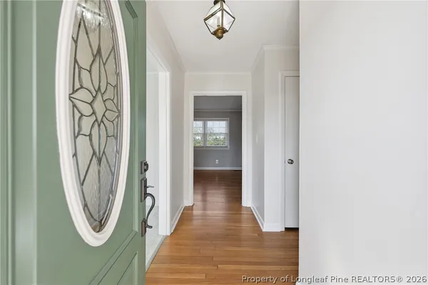 a view of a hallway with wooden floor