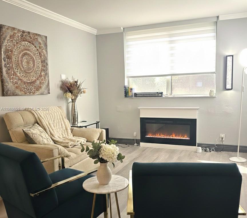 2401 Riverside Drive, Unit 313B Coral Springs, FL 33065 - Photo 4 of 6 a living room with furniture and a fireplace