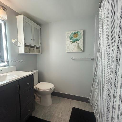 2401 Riverside Drive, Unit 313B Coral Springs, FL 33065 - Photo 5 of 6 a bathroom with a toilet a sink and a window