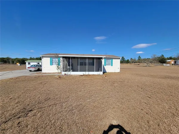 a view of house with outdoor space and parking