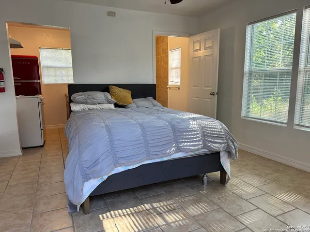 a bedroom with a bed and window