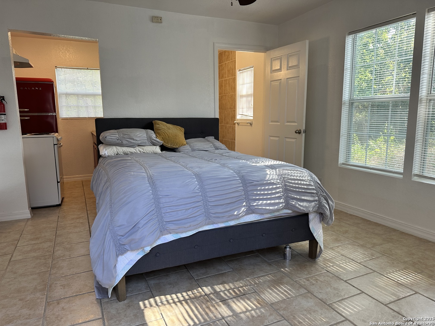 119 East Ridgewood Court, Unit 3 San Antonio, TX 78212 - Photo 3 of 7 a bedroom with a bed and window