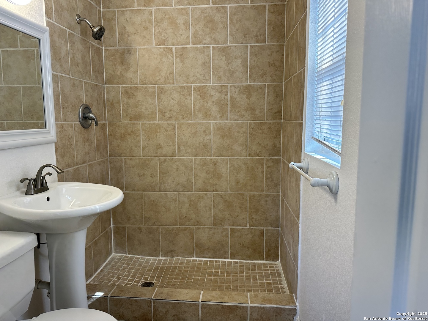 119 East Ridgewood Court, Unit 3 San Antonio, TX 78212 - Photo 4 of 7 a bathroom with a sink toilet shower and a mirror
