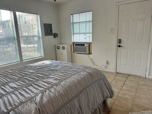 a bedroom with a bed and a window
