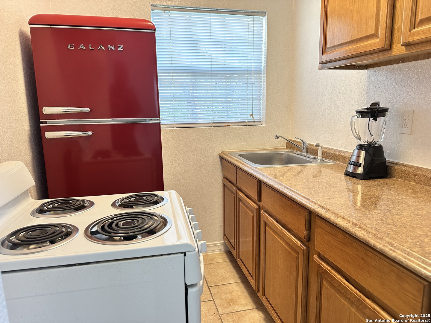 119 East Ridgewood Court, Unit 3 San Antonio, TX 78212 - Photo 7 of 7 a kitchen with a stove and a refrigerator