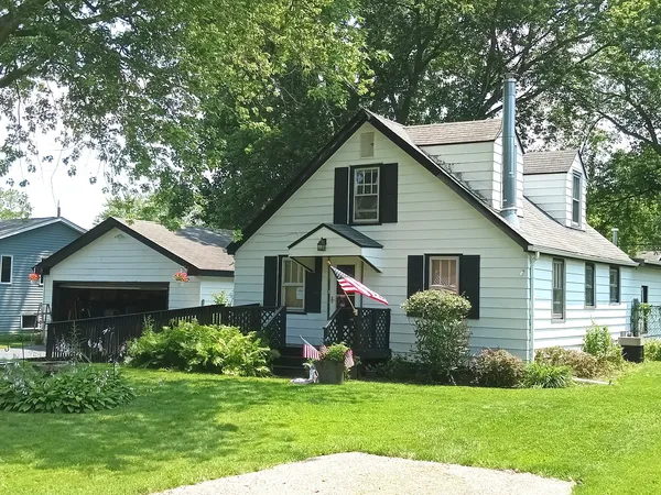 a view of a house with yard and green space