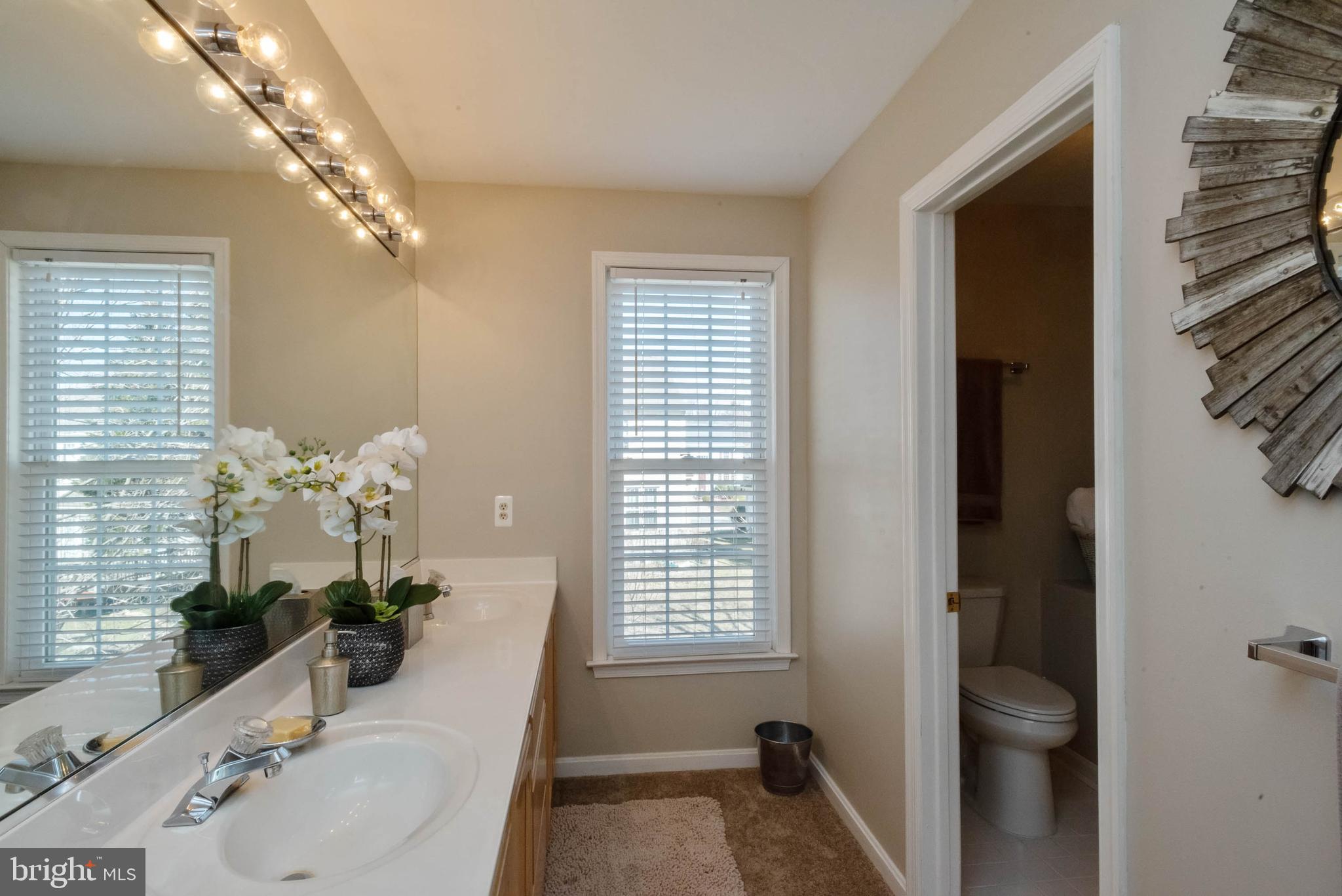 8608 Ashcroft Drive Laurel, MD 20708 - Photo 33 of 45 a bathroom with a granite countertop sink a toilet and shower