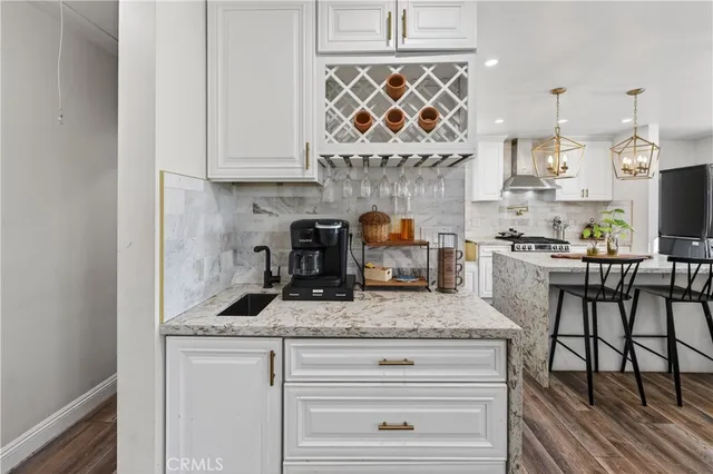 a view of a dining room with furniture a rug and wooden floor