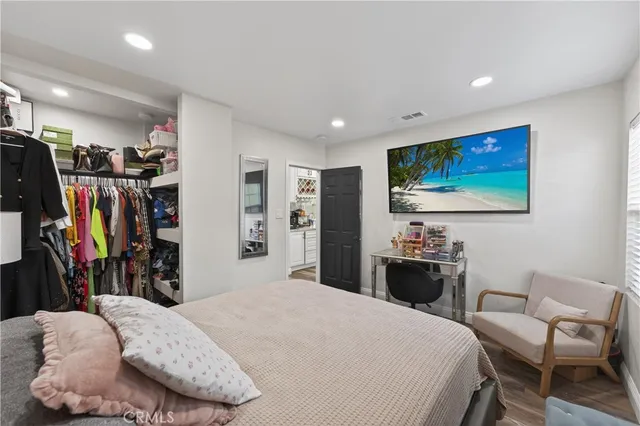a bathroom with a granite countertop sink a mirror a bathtub and shower