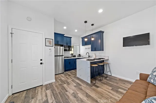 a kitchen with stainless steel appliances granite countertop a refrigerator and a stove top oven