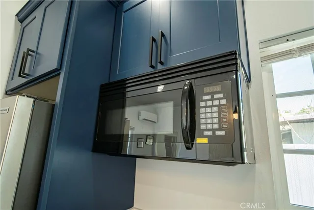 a kitchen with stainless steel appliances a stove sink microwave and cabinets