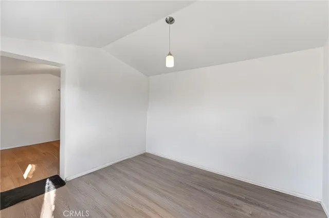 a view of a backyard with table and chairs and potted plants