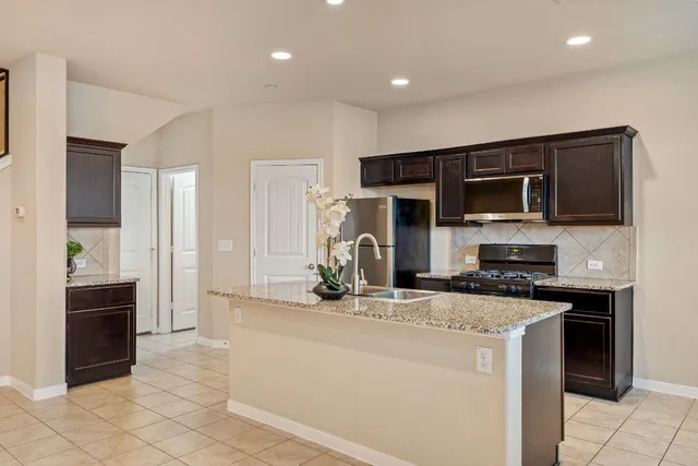 a kitchen with stainless steel appliances a stove sink and microwave