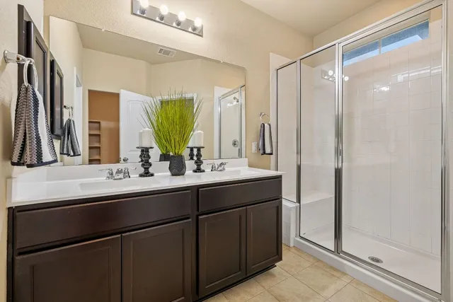 a bathroom with a double vanity sink mirror and double