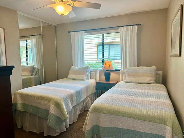 a bedroom with two beds and a chandelier