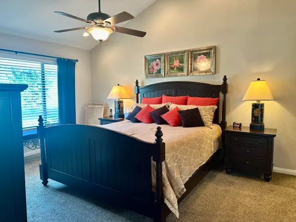 a bedroom with a bed and a chandelier